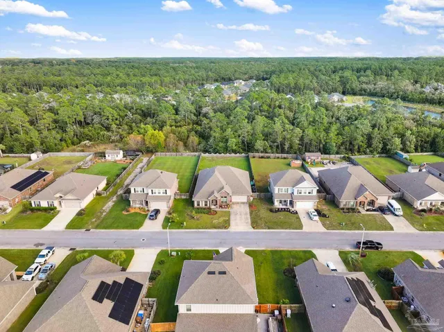 an aerial view of residential houses with outdoor space and street view