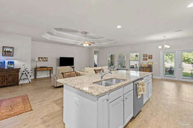 a kitchen with center island and living room