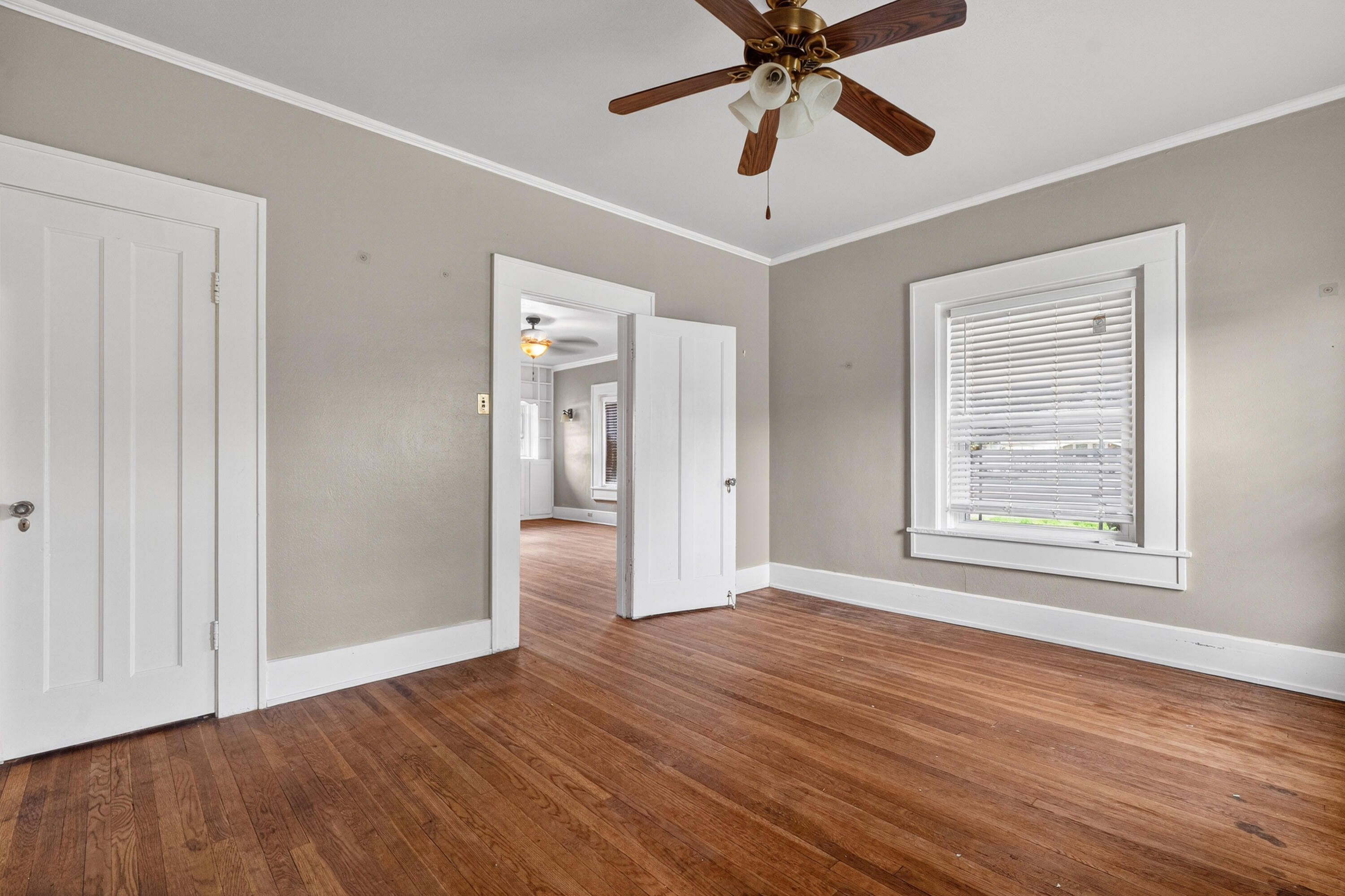 500 West Garza Street Slaton, TX 79364 - Photo 7 of 24 a view of an empty room with window and wooden floor