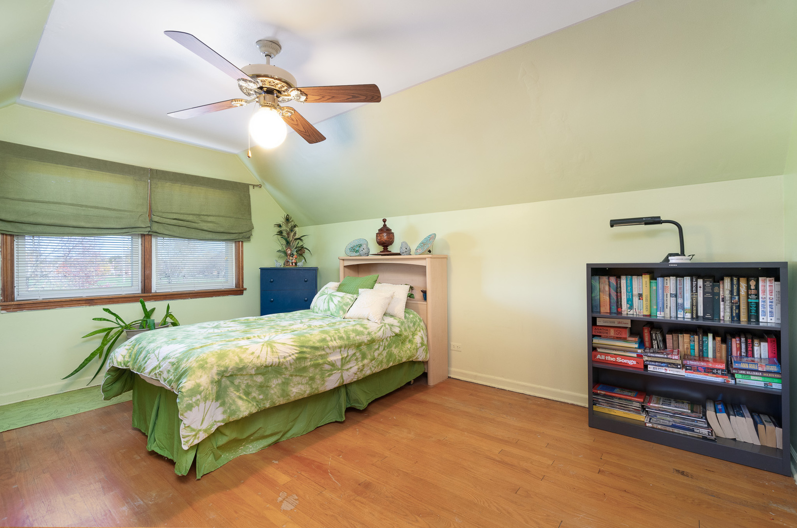 4225 West Marquette Road Chicago, IL 60629 - Photo 18 of 26 a bedroom with a bed and a book shelf