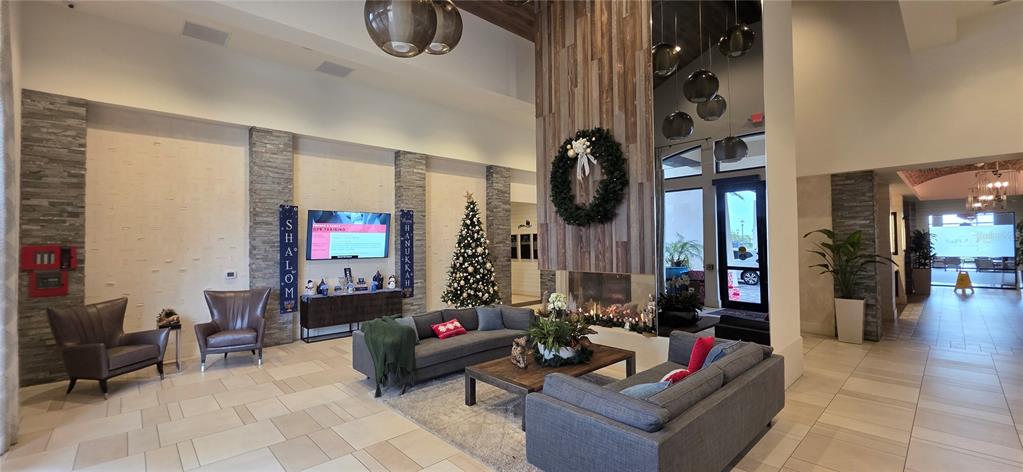 13608 Messina Loop, Unit 202 Bradenton, FL 34211 - Photo 44 of 73 a living room with furniture and a fireplace