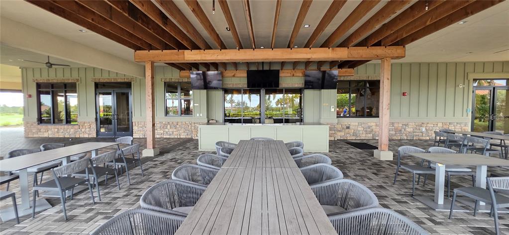 13608 Messina Loop, Unit 202 Bradenton, FL 34211 - Photo 52 of 73 a view of a patio with a dining table and chairs