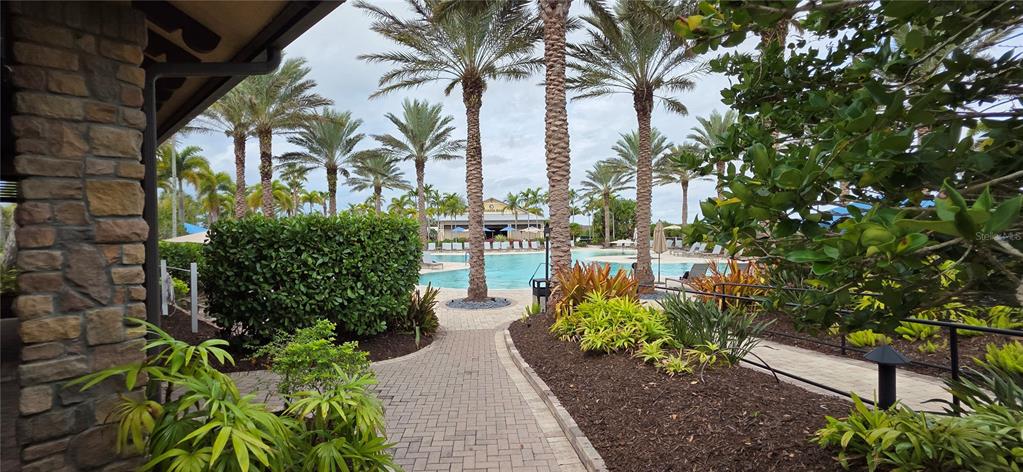 13608 Messina Loop, Unit 202 Bradenton, FL 34211 - Photo 55 of 73 a view of a garden with a fountain and a bench