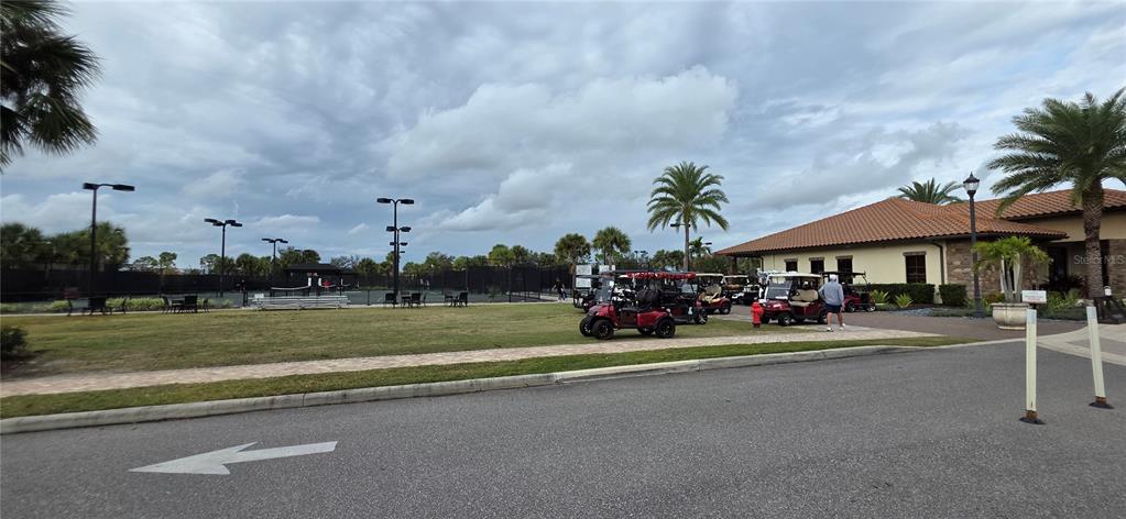 13608 Messina Loop, Unit 202 Bradenton, FL 34211 - Photo 66 of 73 a view of a street with cars parked in front of it