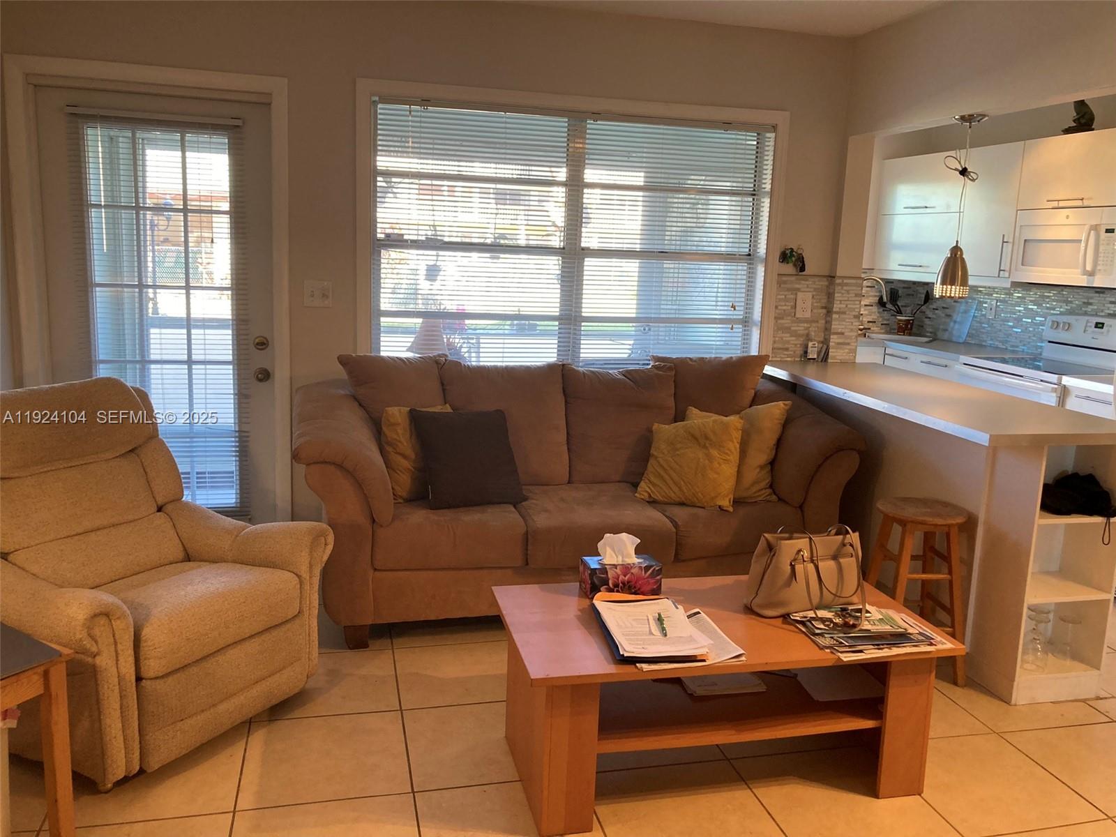 5300 Washington Street, Unit N117 Hollywood, FL 33021 - Photo 18 of 99 a living room with furniture and a window