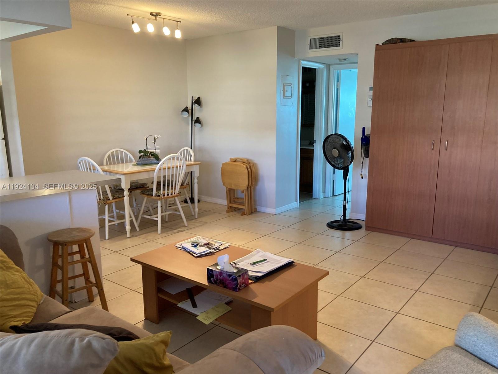 5300 Washington Street, Unit N117 Hollywood, FL 33021 - Photo 22 of 99 a living room with furniture a rug and a chandelier