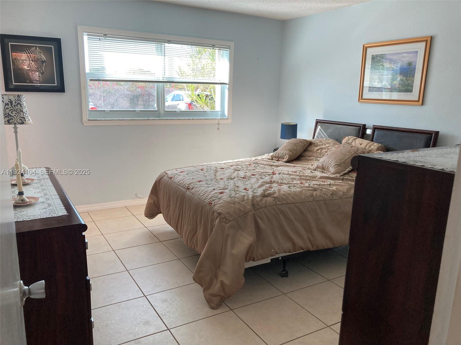 5300 Washington Street, Unit N117 Hollywood, FL 33021 - Photo 41 of 99 a bedroom with a bed and a window