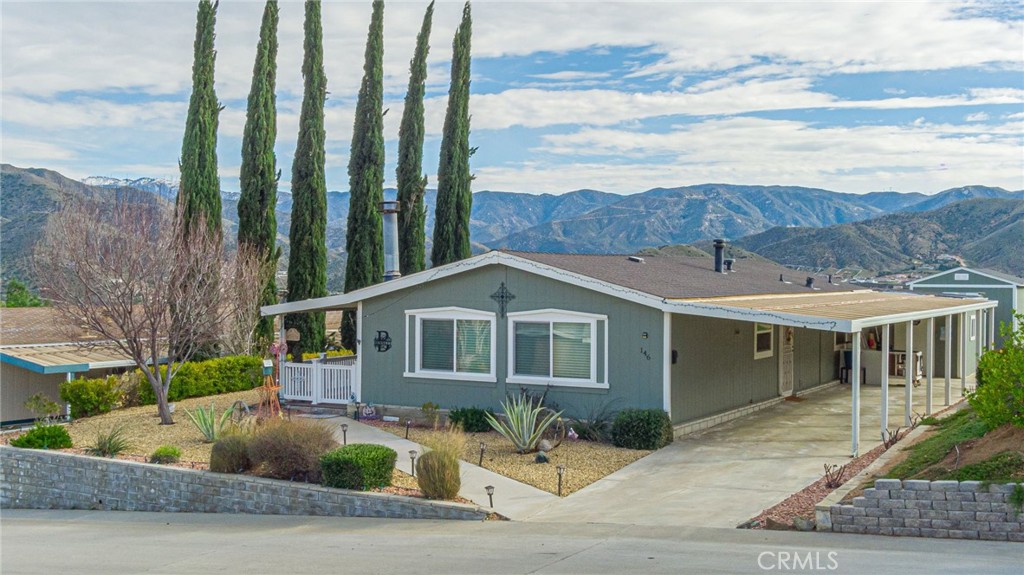33105 Santiago Road, Unit 146 Acton, CA 93510 - Photo 1 of 1 a front view of a house with a yard and garage