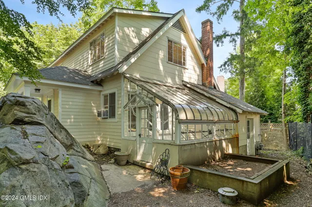 a backyard of a house with outdoor seating