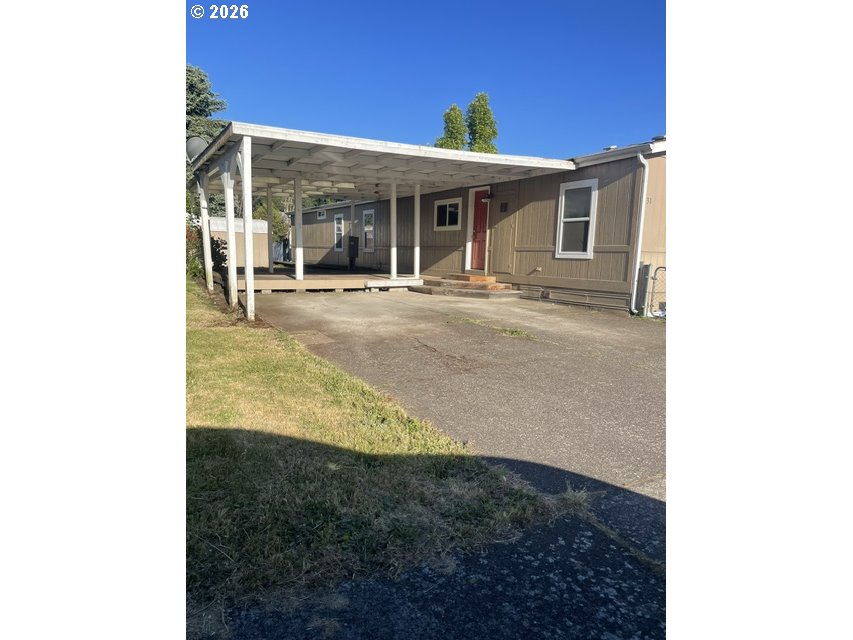 5660 Daisy Street, Unit 31 Springfield, OR 97478 - Photo 12 of 44 a view of a house with backyard porch and sitting area