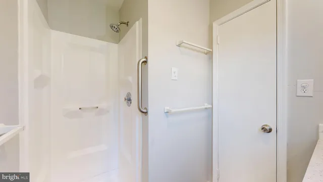 a bathroom with a glass shower door