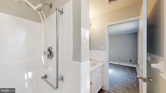 a bathroom with a sink toilet and mirror