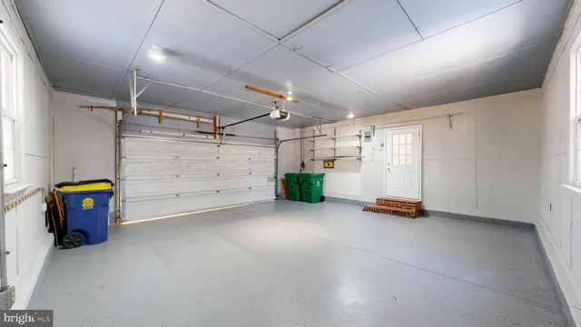 a view of backyard with large trees and wooden fence