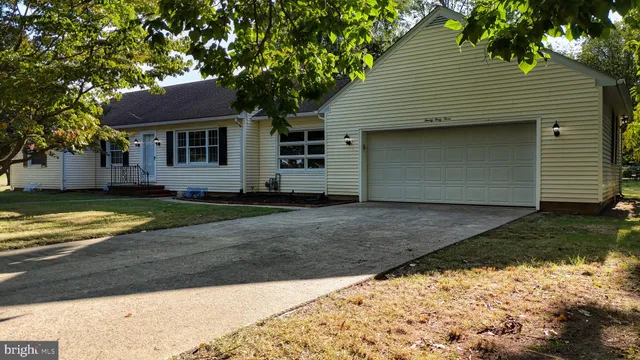 a backyard of a house with swimming pool and trees