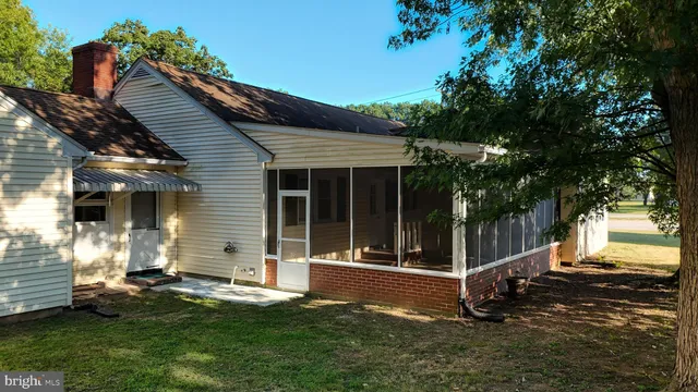 a view of a house with a tree in the background