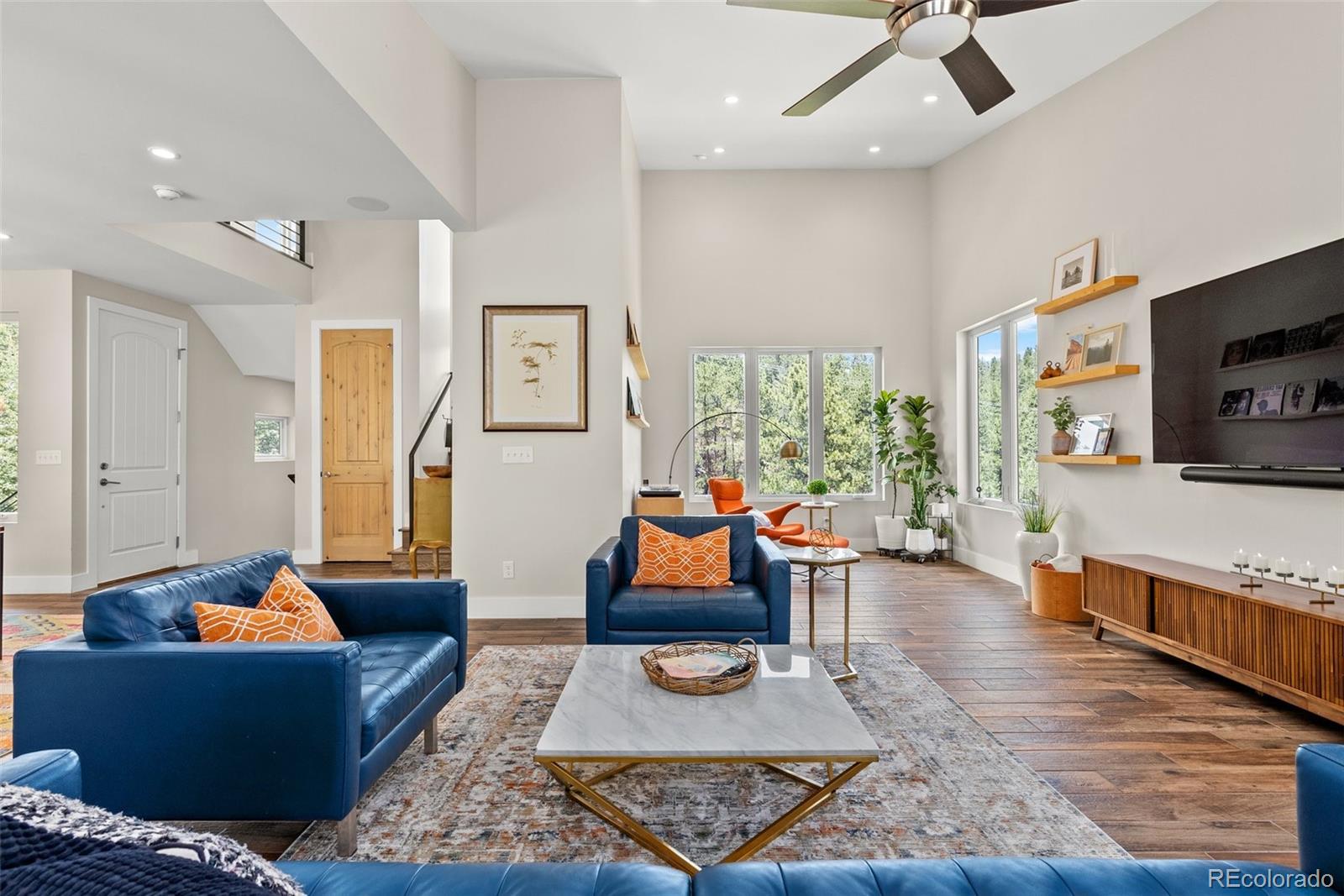 9218 South Turkey Creek Road Morrison, CO 80465 - Photo 12 of 44 a living room with furniture and a flat screen tv