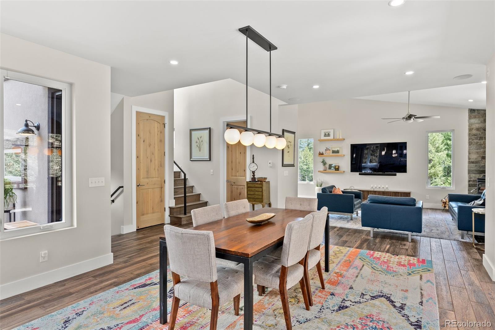 9218 South Turkey Creek Road Morrison, CO 80465 - Photo 16 of 44 a living room with furniture a flat screen tv and a wooden floor