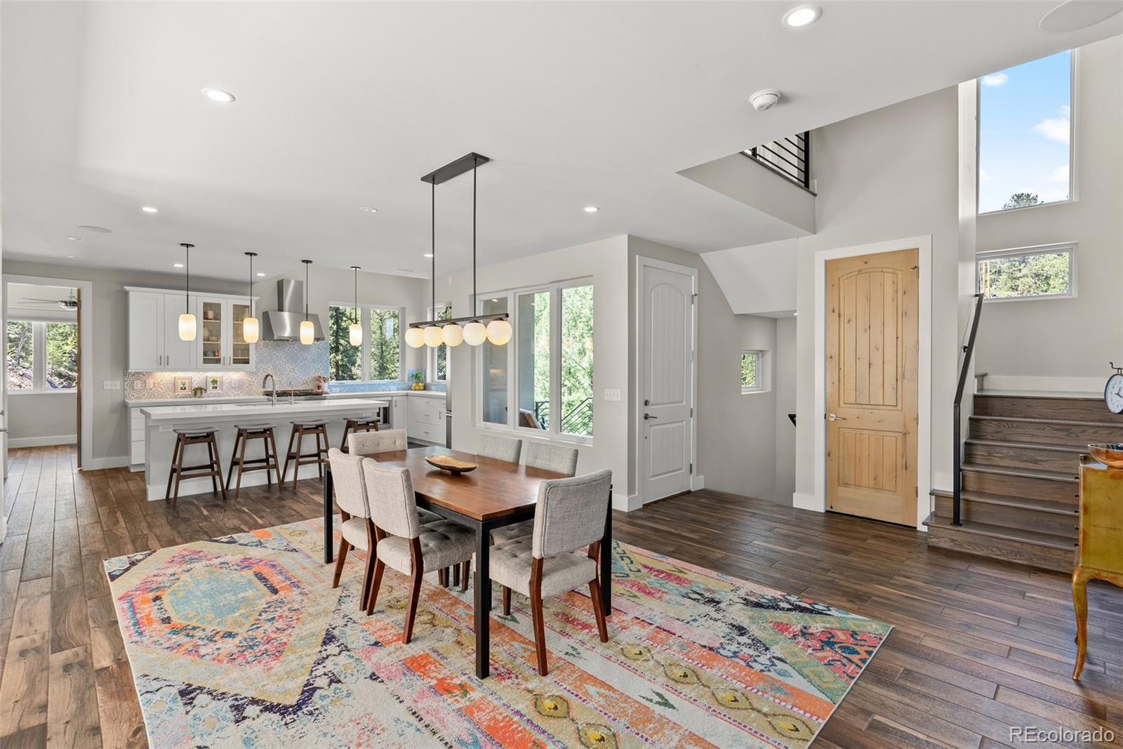 9218 South Turkey Creek Road Morrison, CO 80465 - Photo 17 of 44 a workspace with furniture wooden floor and a chandelier