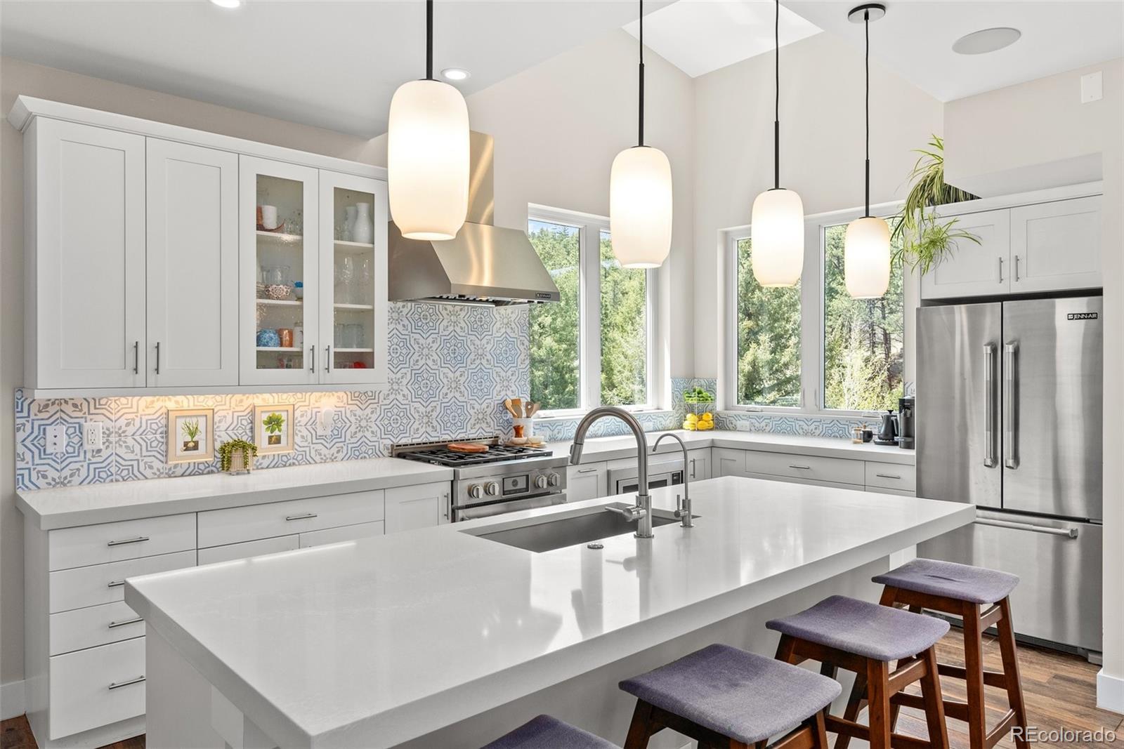 9218 South Turkey Creek Road Morrison, CO 80465 - Photo 18 of 44 a kitchen with stainless steel appliances granite countertop a sink a stove and a wooden floors