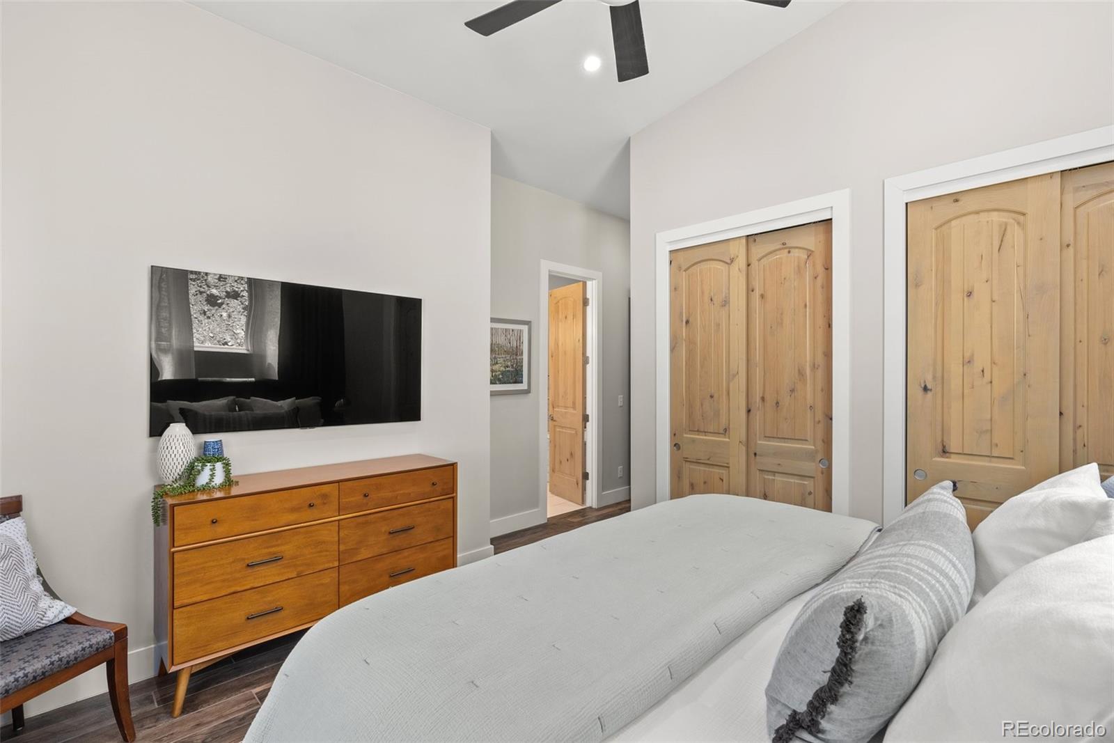 9218 South Turkey Creek Road Morrison, CO 80465 - Photo 20 of 44 a bedroom with a bed and flat screen tv