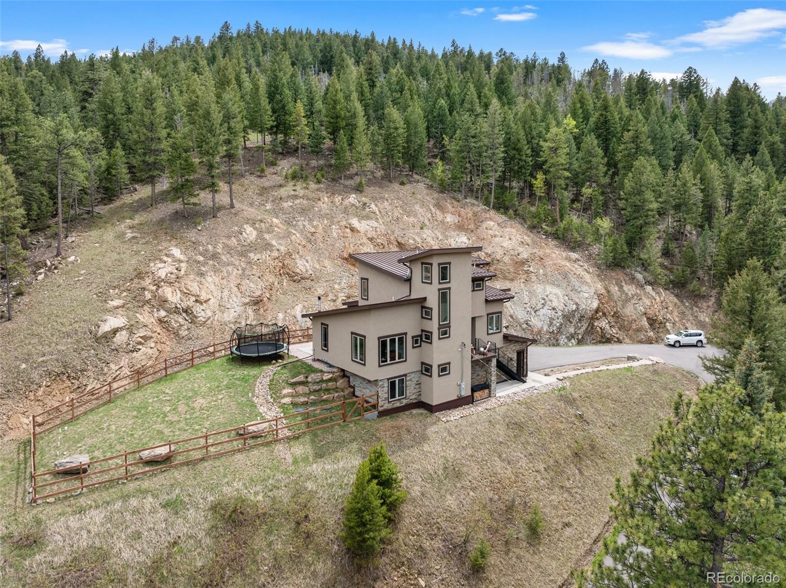 9218 South Turkey Creek Road Morrison, CO 80465 - Photo 2 of 44 an aerial view of a house with a yard