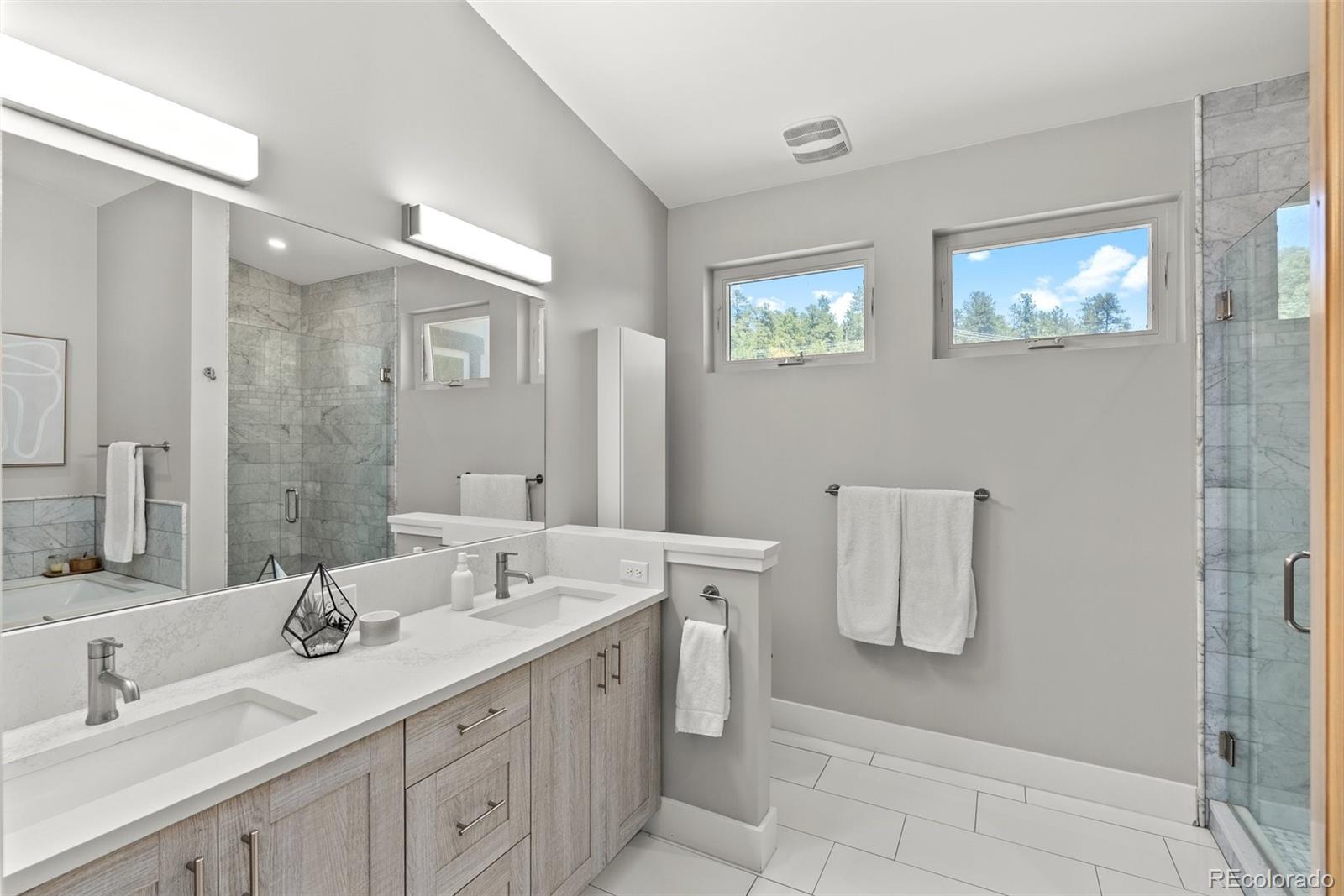 9218 South Turkey Creek Road Morrison, CO 80465 - Photo 21 of 44 a bathroom with a double vanity sink mirror and