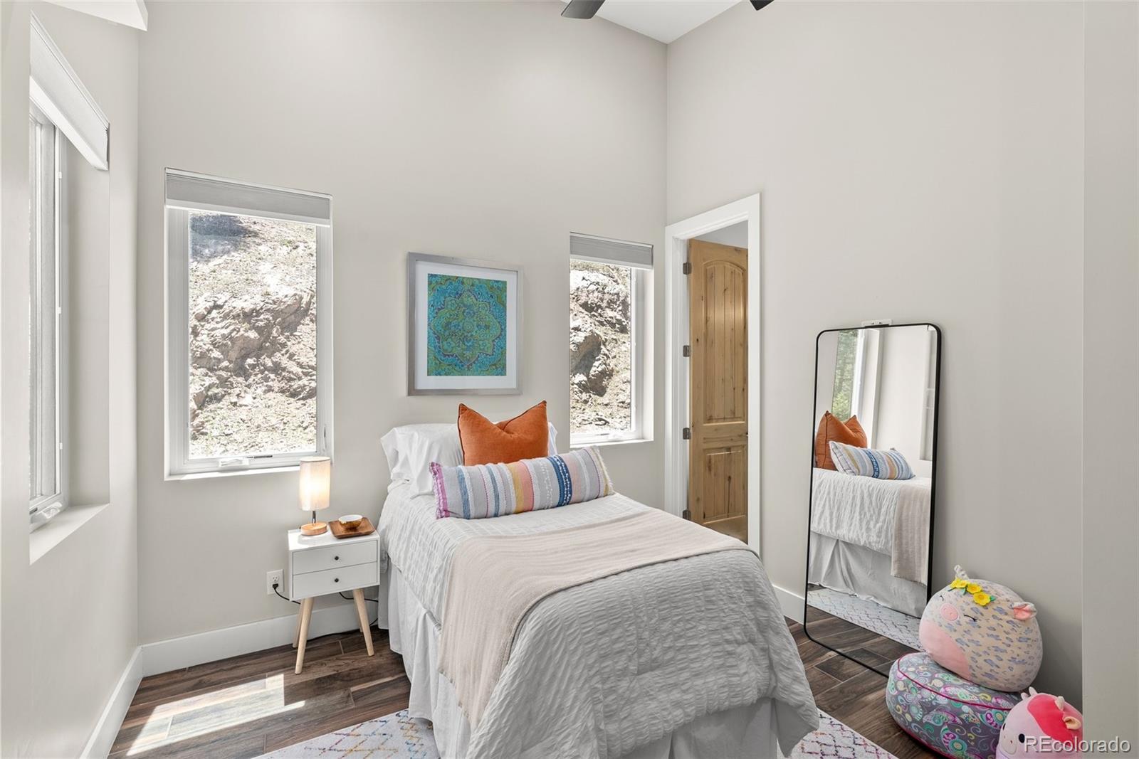 9218 South Turkey Creek Road Morrison, CO 80465 - Photo 22 of 44 a bedroom with a bed and a window