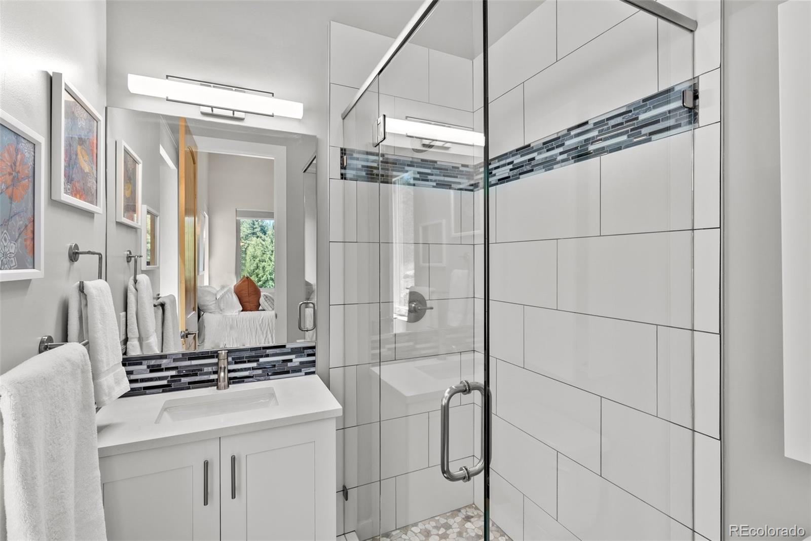 9218 South Turkey Creek Road Morrison, CO 80465 - Photo 23 of 44 a bathroom with a sink and a mirror