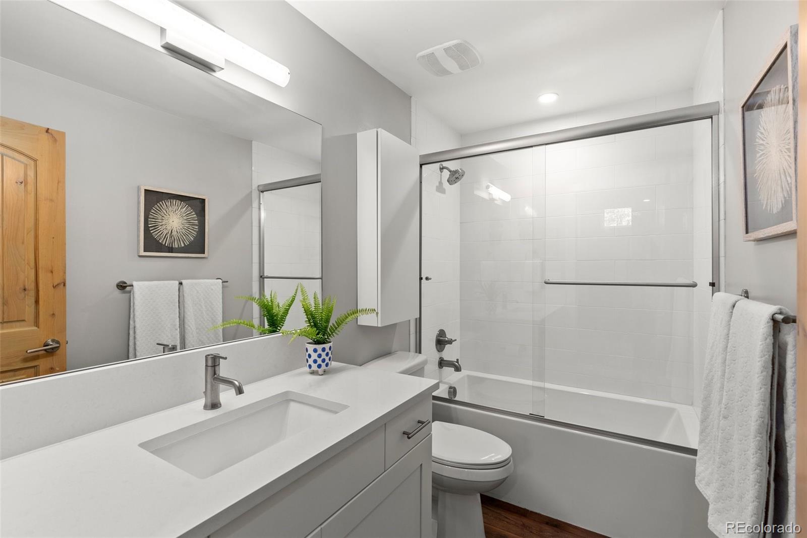 9218 South Turkey Creek Road Morrison, CO 80465 - Photo 27 of 44 a bathroom with a granite countertop sink toilet and shower
