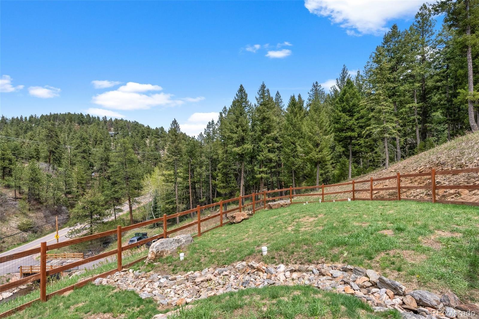 9218 South Turkey Creek Road Morrison, CO 80465 - Photo 3 of 44 a view of a yard with wooden fence