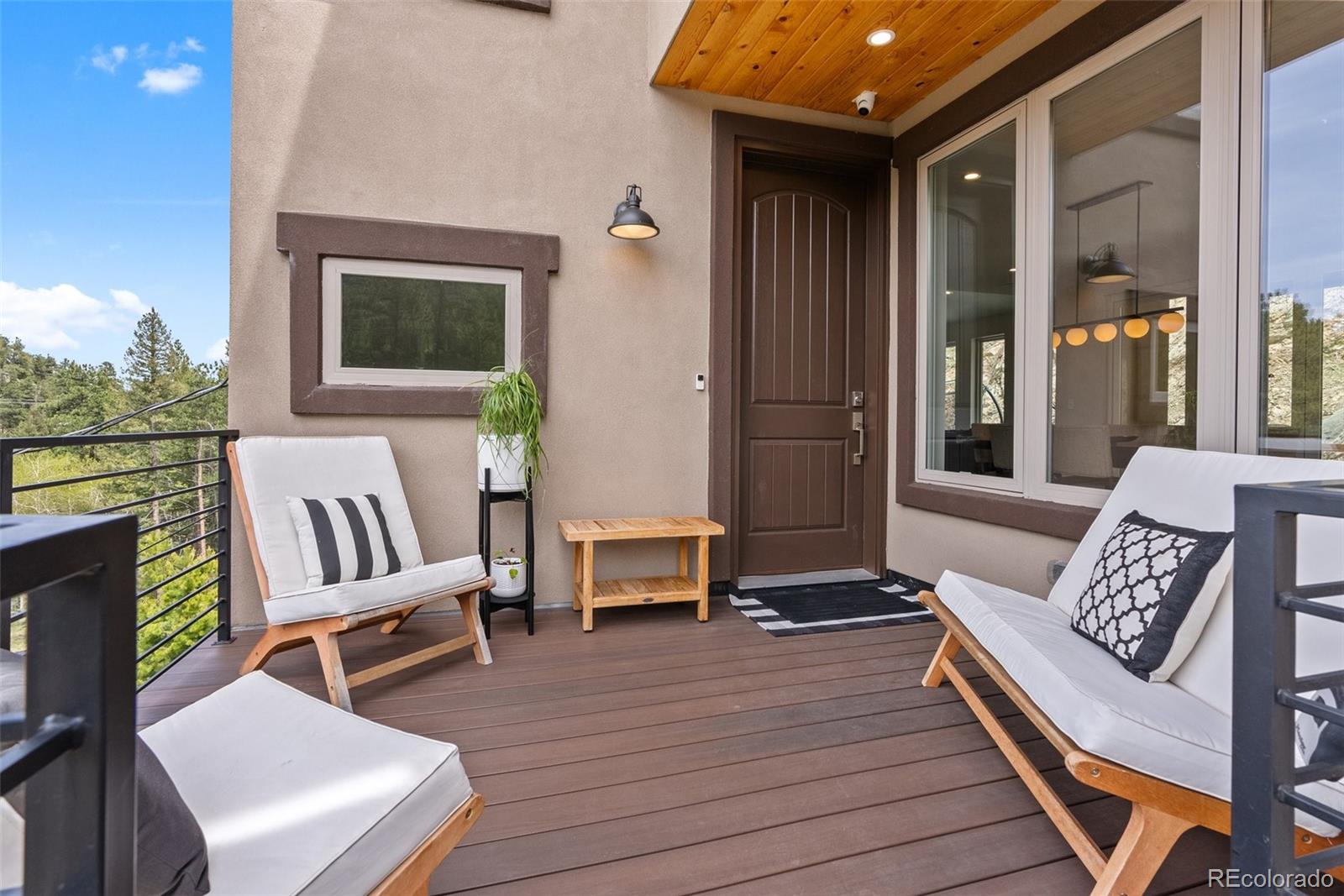 9218 South Turkey Creek Road Morrison, CO 80465 - Photo 32 of 44 a balcony with furniture and wooden floor