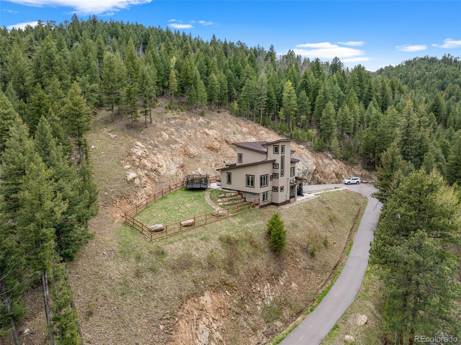 9218 South Turkey Creek Road Morrison, CO 80465 - Photo 41 of 44 a view of a house with a yard