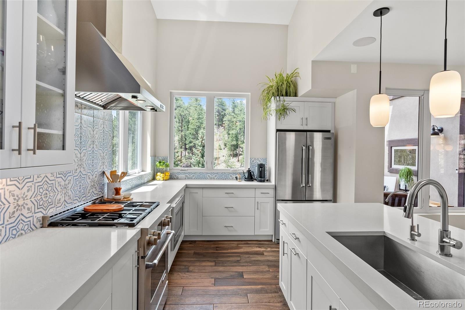 9218 South Turkey Creek Road Morrison, CO 80465 - Photo 6 of 44 a kitchen with a sink stove and refrigerator