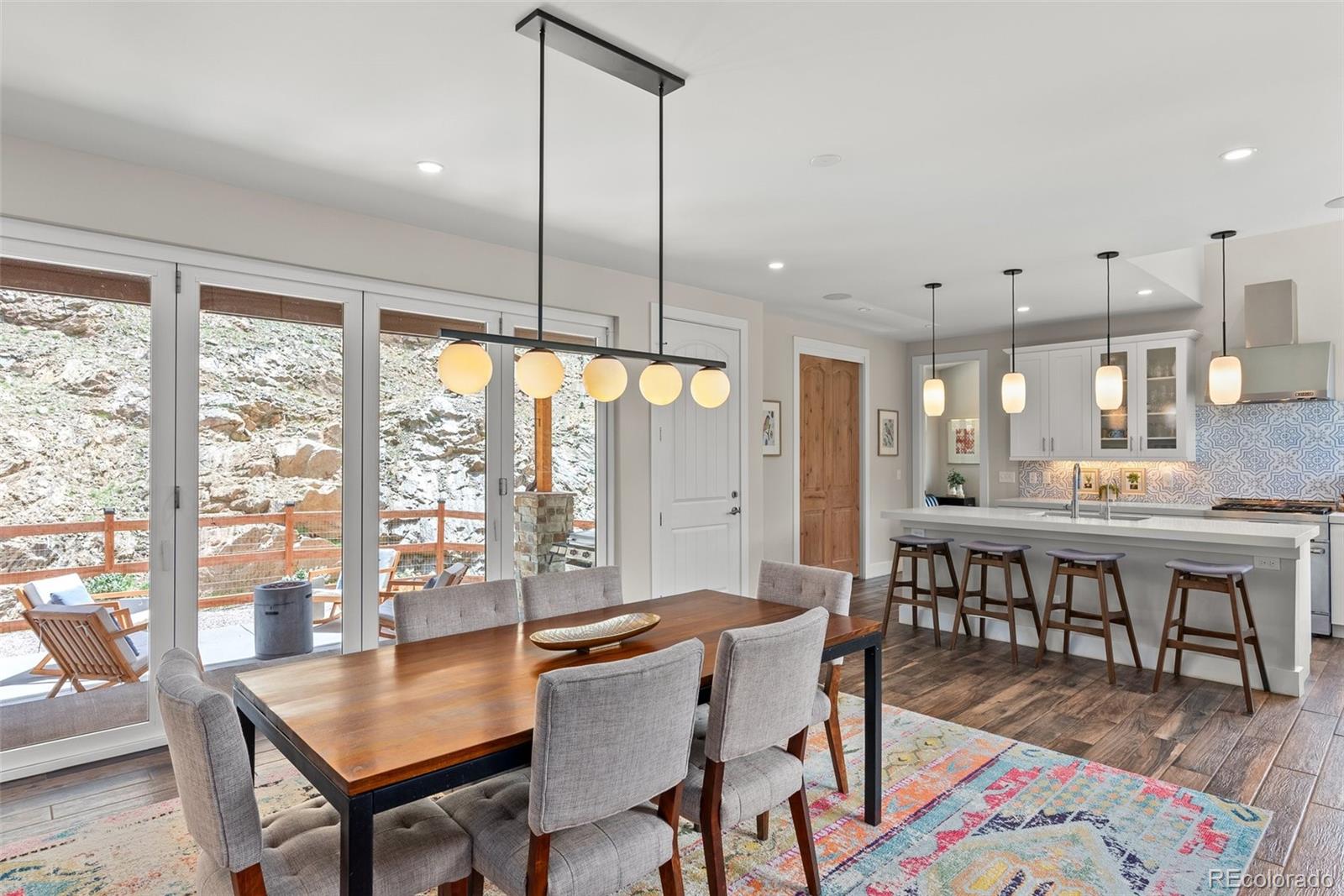 9218 South Turkey Creek Road Morrison, CO 80465 - Photo 7 of 44 a dining room with furniture a chandelier and wooden floor