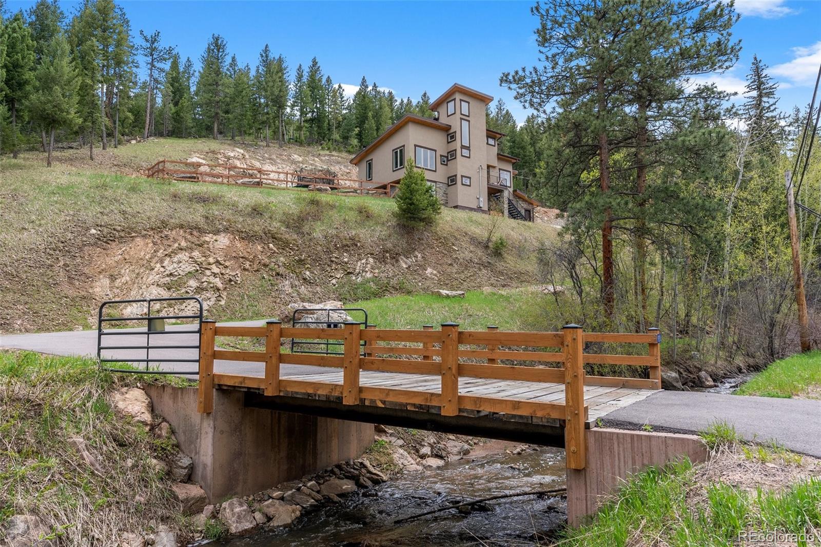 9218 South Turkey Creek Road Morrison, CO 80465 - Photo 9 of 44 a view of a pathway with a wrought fence