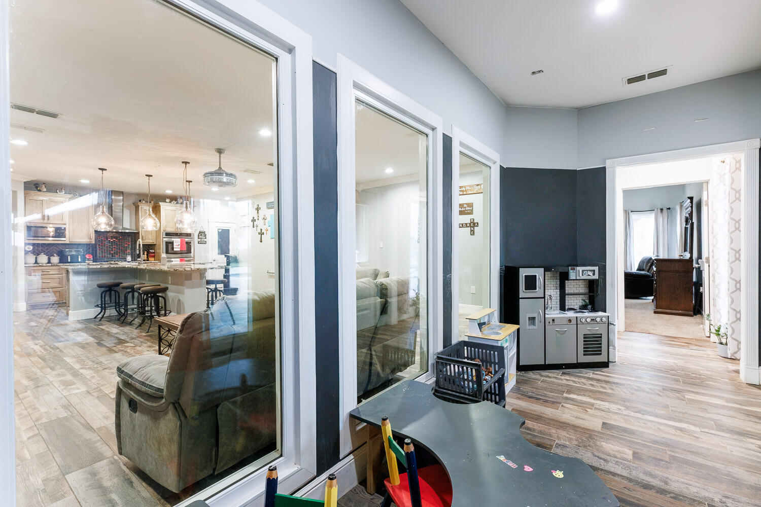 6523 East C R 6200 Lubbock, TX 79403 - Photo 21 of 86 a kitchen with stainless steel appliances kitchen island granite countertop a refrigerator a stove and a wooden cabinets with wooden floor