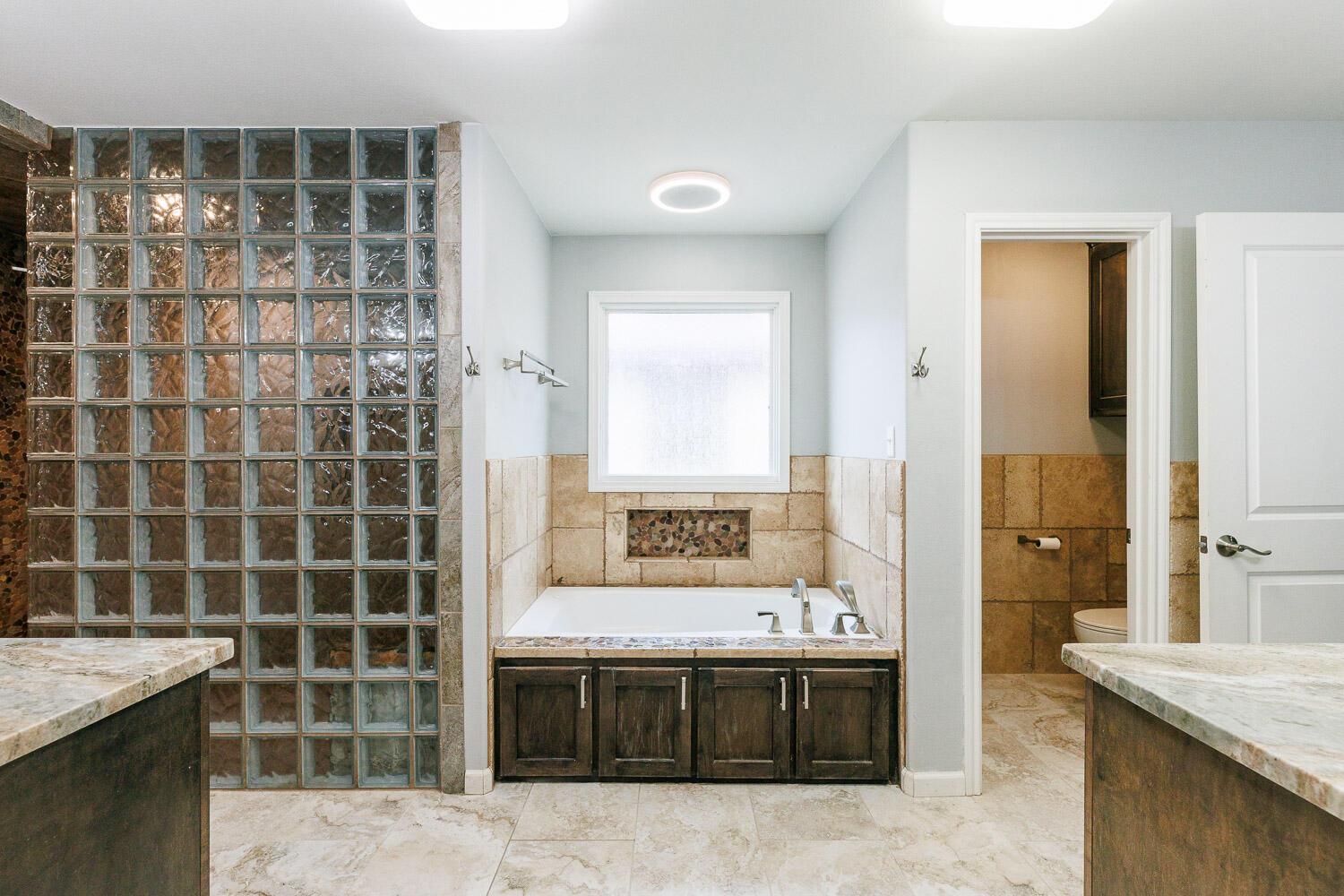 6523 East C R 6200 Lubbock, TX 79403 - Photo 35 of 86 a bathroom with a granite countertop tub a sink and a shower