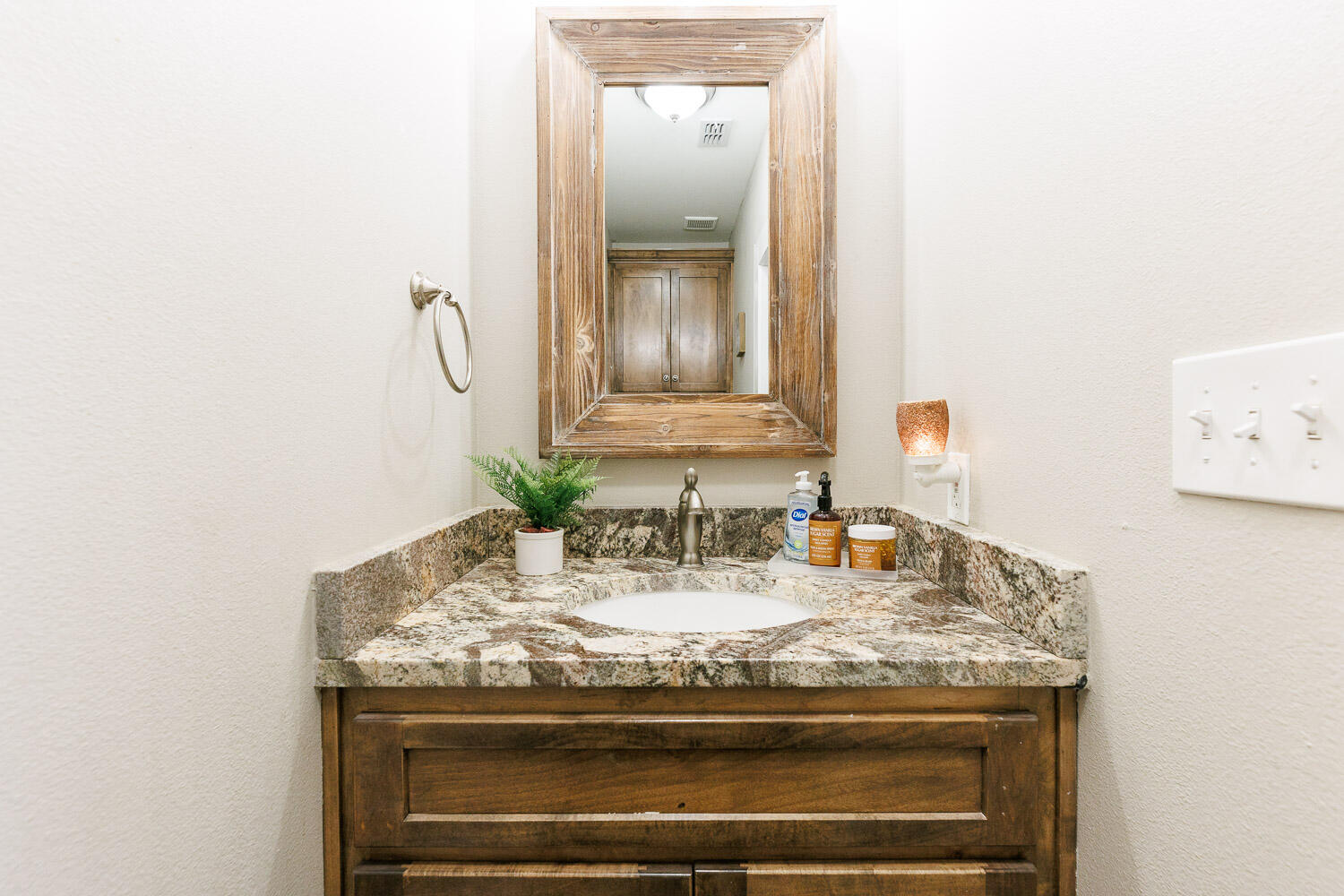 6523 East C R 6200 Lubbock, TX 79403 - Photo 50 of 86 a bathroom with a granite countertop sink and a mirror