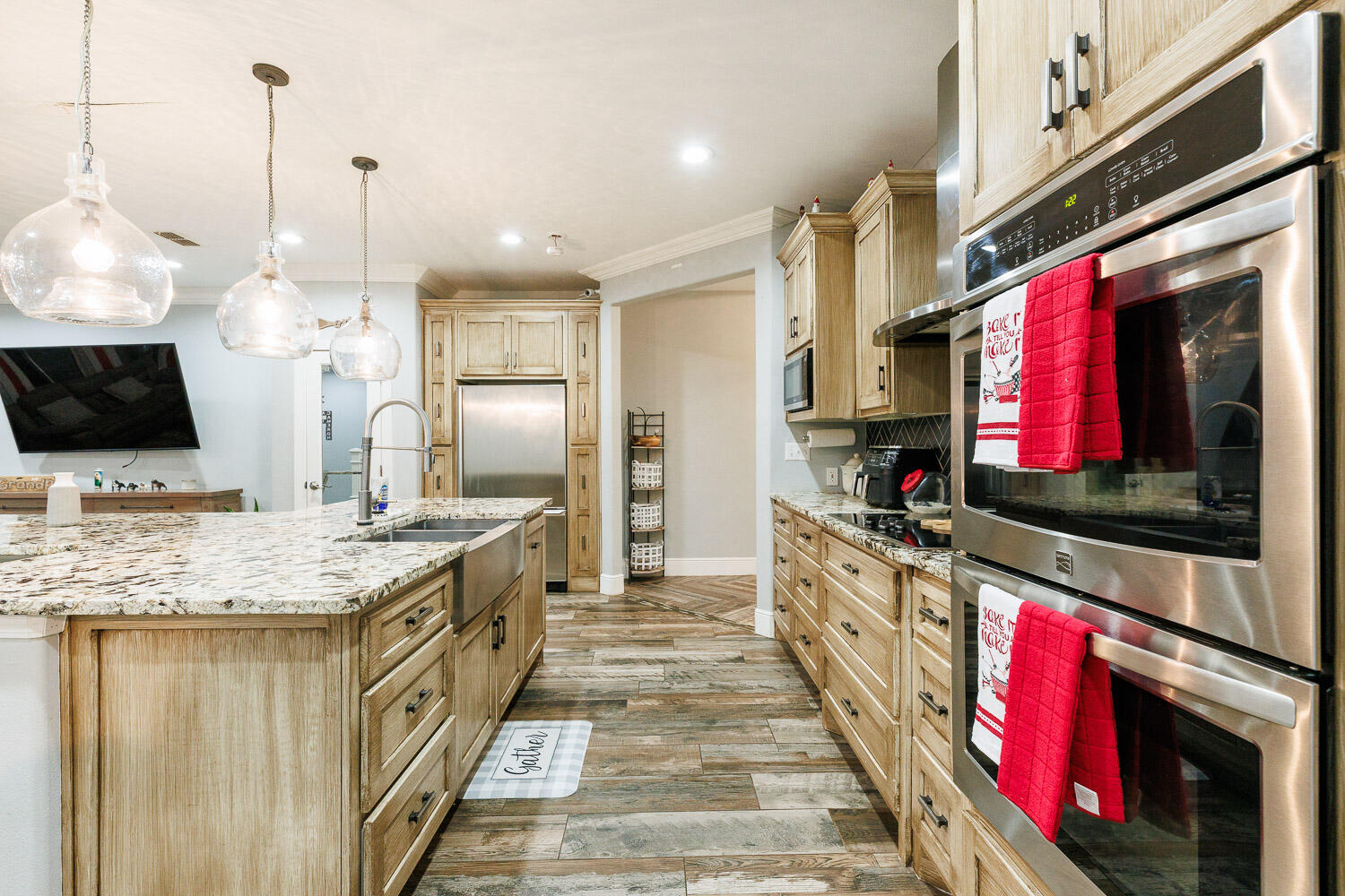 6523 East C R 6200 Lubbock, TX 79403 - Photo 10 of 86 a kitchen with stainless steel appliances kitchen island granite countertop a stove a sink and a microwave