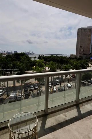 a view of a chairs and table in the balcony