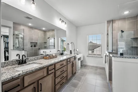 a large bathroom with a granite countertop sink mirror and a
