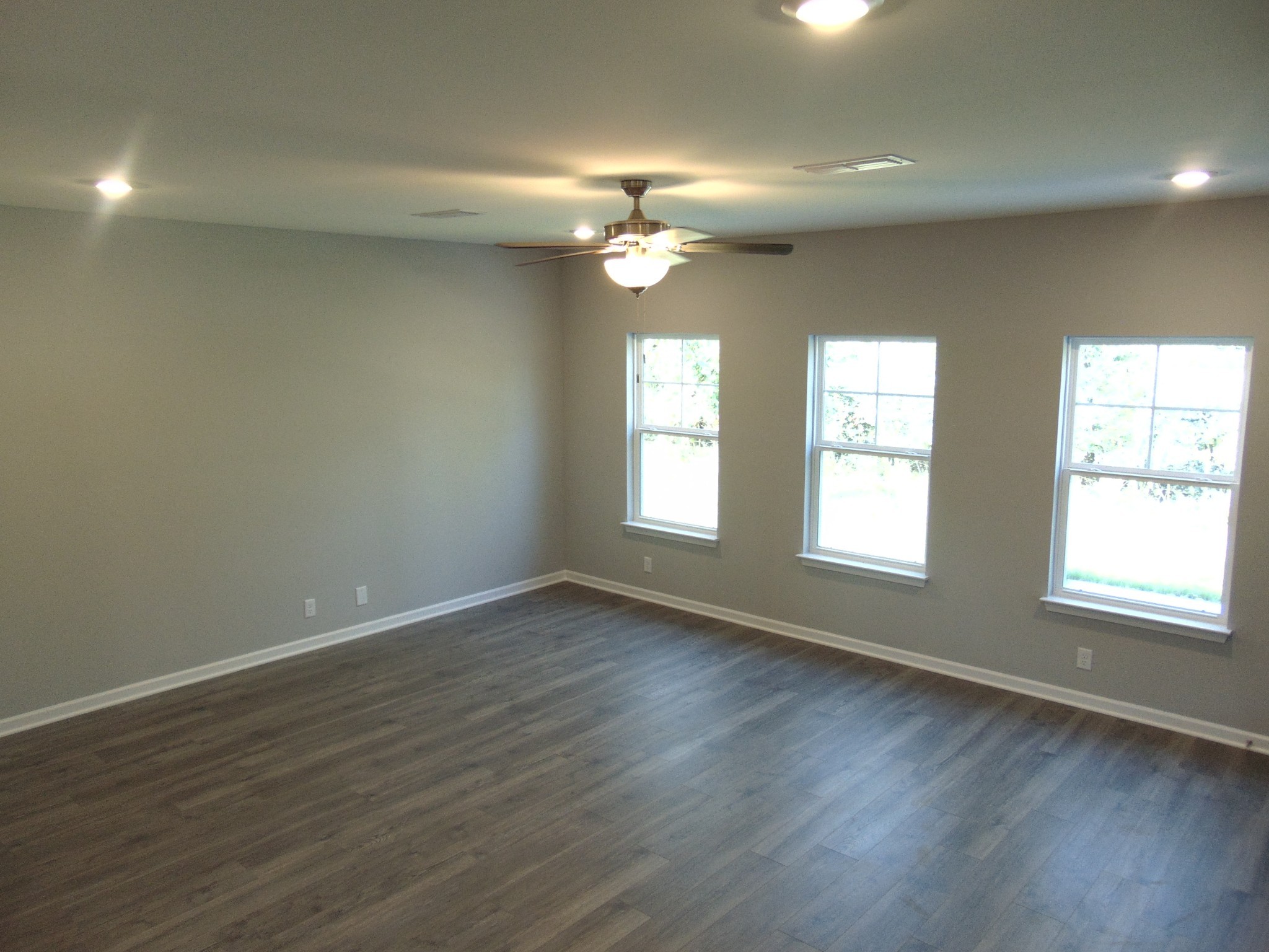279 Spring Street La Vergne, TN 37086 - Photo 6 of 31 an empty room with wooden floor and windows