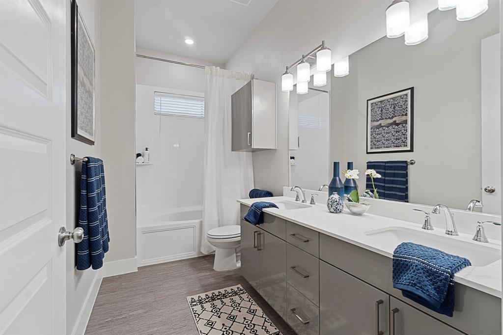 579 Lloyd's Road, Unit 821A Little Elm, TX 75068 - Photo 20 of 25 a spacious bathroom with a granite countertop sink a toilet and a mirror