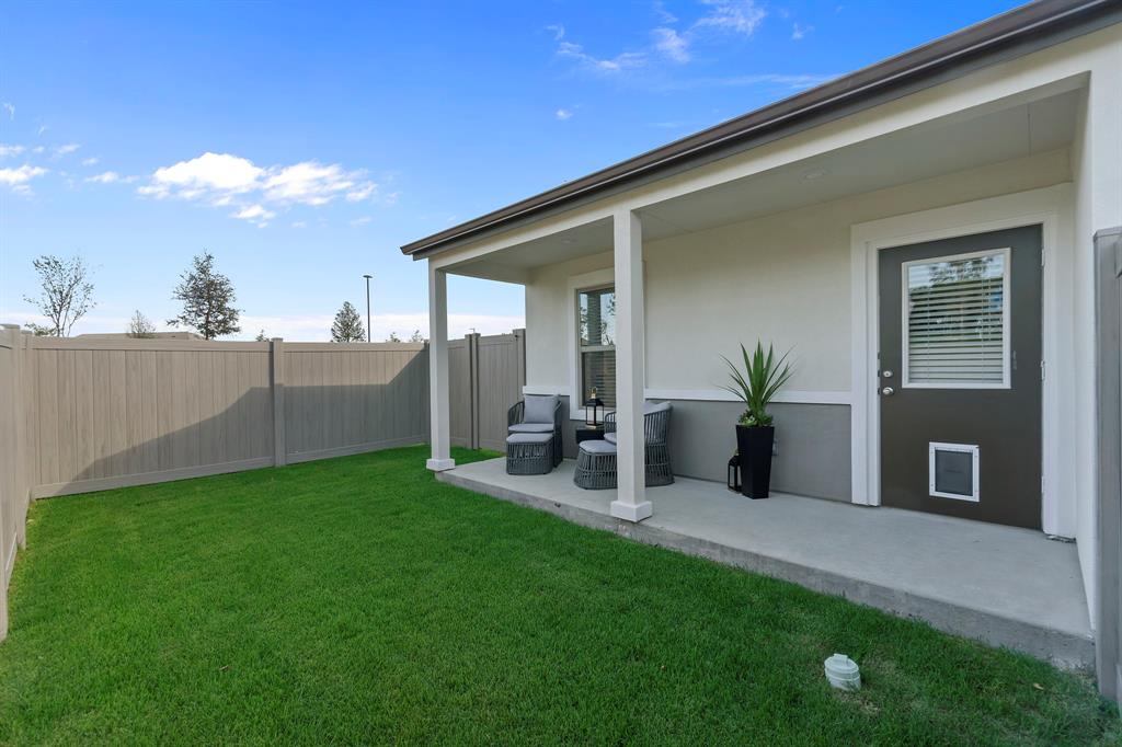 579 Lloyd's Road, Unit 821A Little Elm, TX 75068 - Photo 24 of 25 a view of a house with backyard and porch