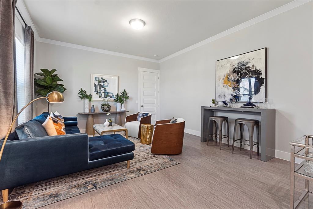 579 Lloyd's Road, Unit 821A Little Elm, TX 75068 - Photo 3 of 25 a living room with furniture and a wooden floor