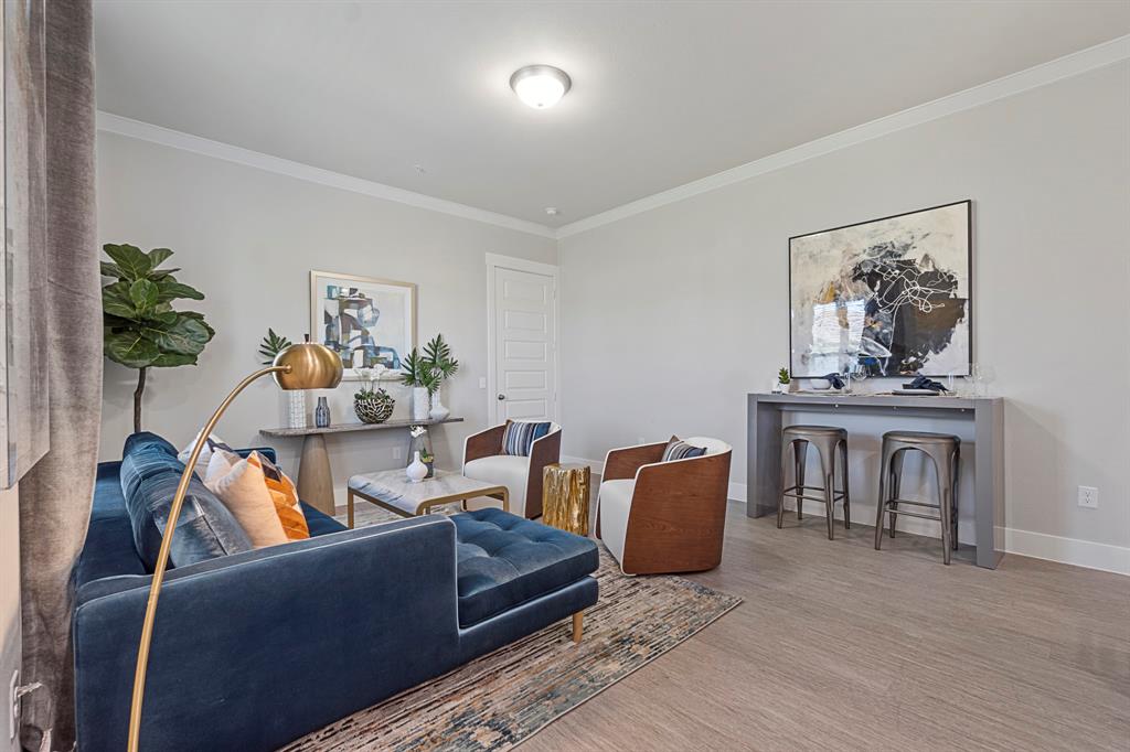 579 Lloyd's Road, Unit 821A Little Elm, TX 75068 - Photo 7 of 25 a living room with furniture and a potted plant