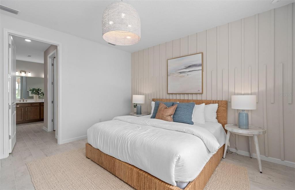 2386 Lily Bloom Road St. Cloud, FL 34771 - Photo 13 of 14 a bedroom with a bed and a chandelier