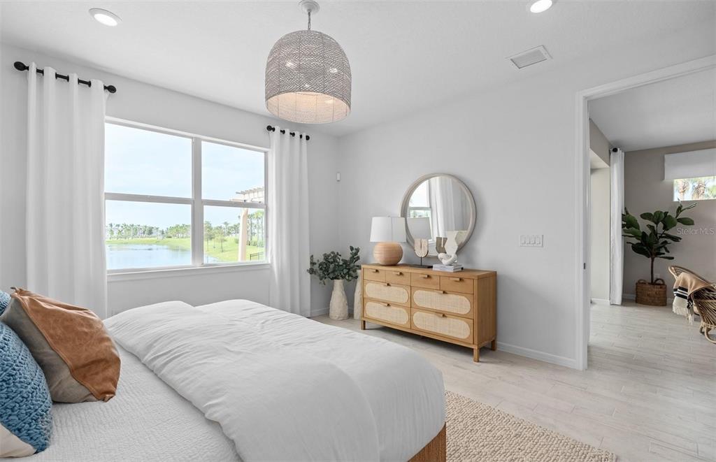 2386 Lily Bloom Road St. Cloud, FL 34771 - Photo 14 of 14 a bedroom with a bed and a chandelier