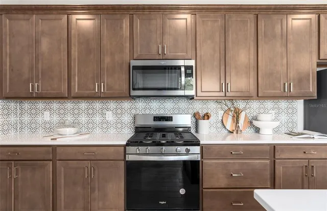 a kitchen with center island and stainless steel appliances
