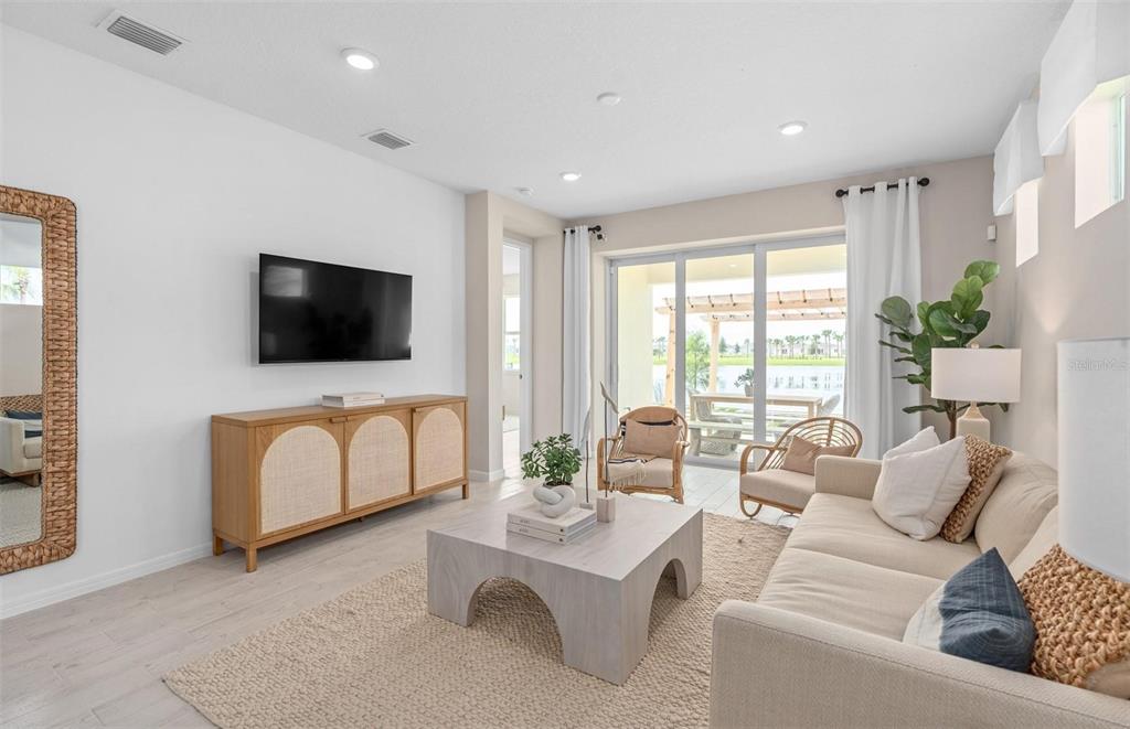 2386 Lily Bloom Road St. Cloud, FL 34771 - Photo 10 of 14 a living room with furniture and a flat screen tv